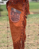 Premium hand-tooled leather chaps with fringe, designed in Native American western style for bull riding and rodeo competitions. Custom-fit cowboy gear built for durability and style